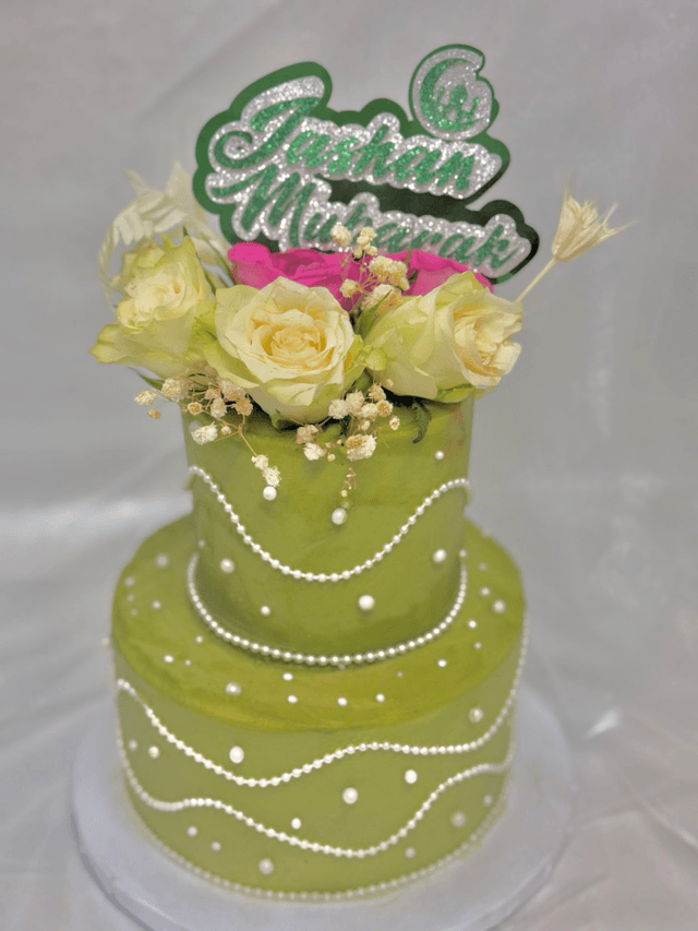 Green 2 tier Birthday Cake adorned with pearls &amp; fresh flowers