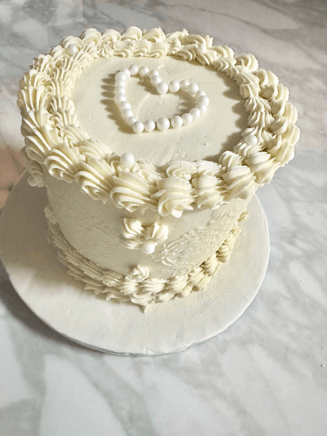 Elegant white Birthday cake decorated with edible pearls
